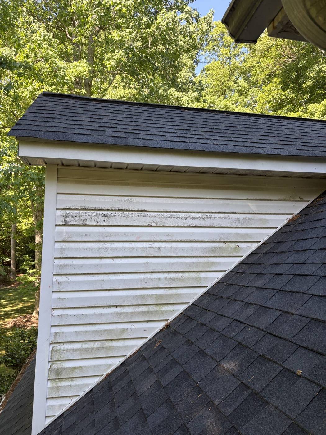 Second story dormer siding covered in dirt and grime before a soft wash