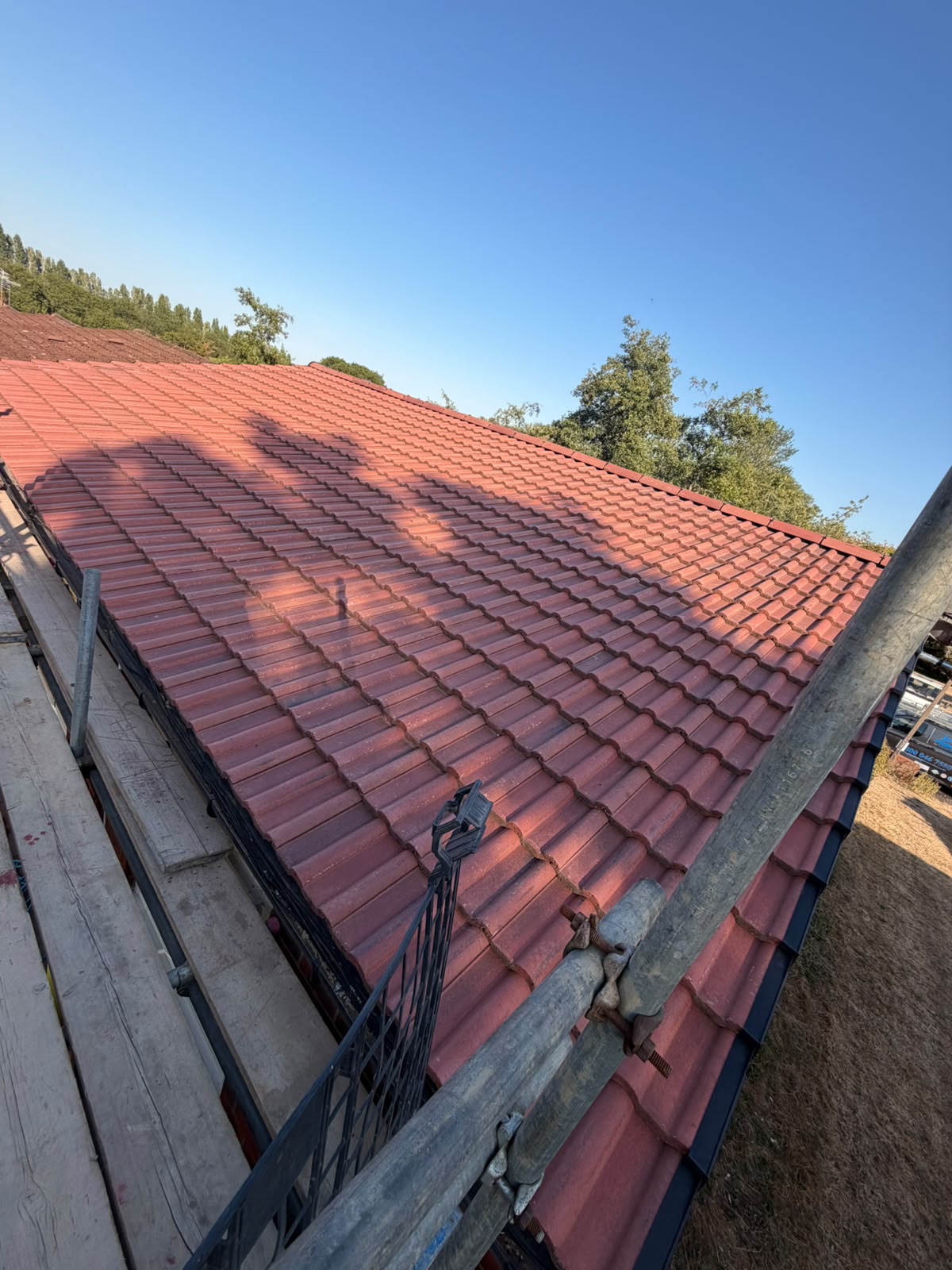 Newly installed red terracotta interlocking concrete tile roof