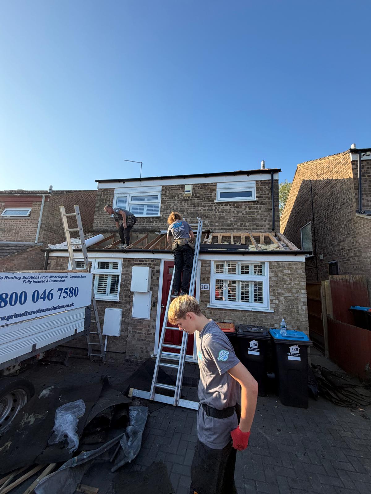 Primefix roofing team installing new roof structure on residential property with company van