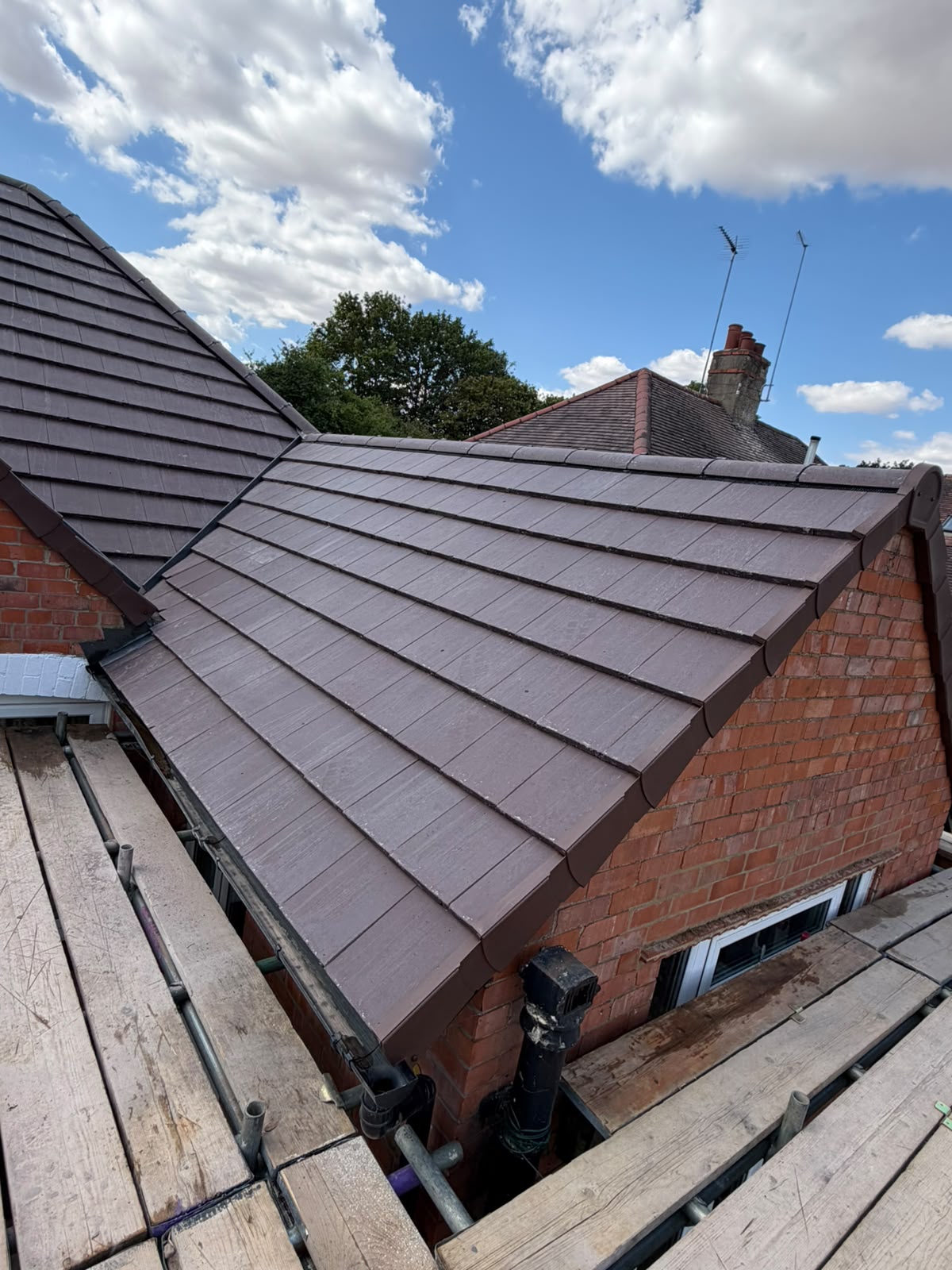 Complete extension tiled roof installation with dry verge and guttering