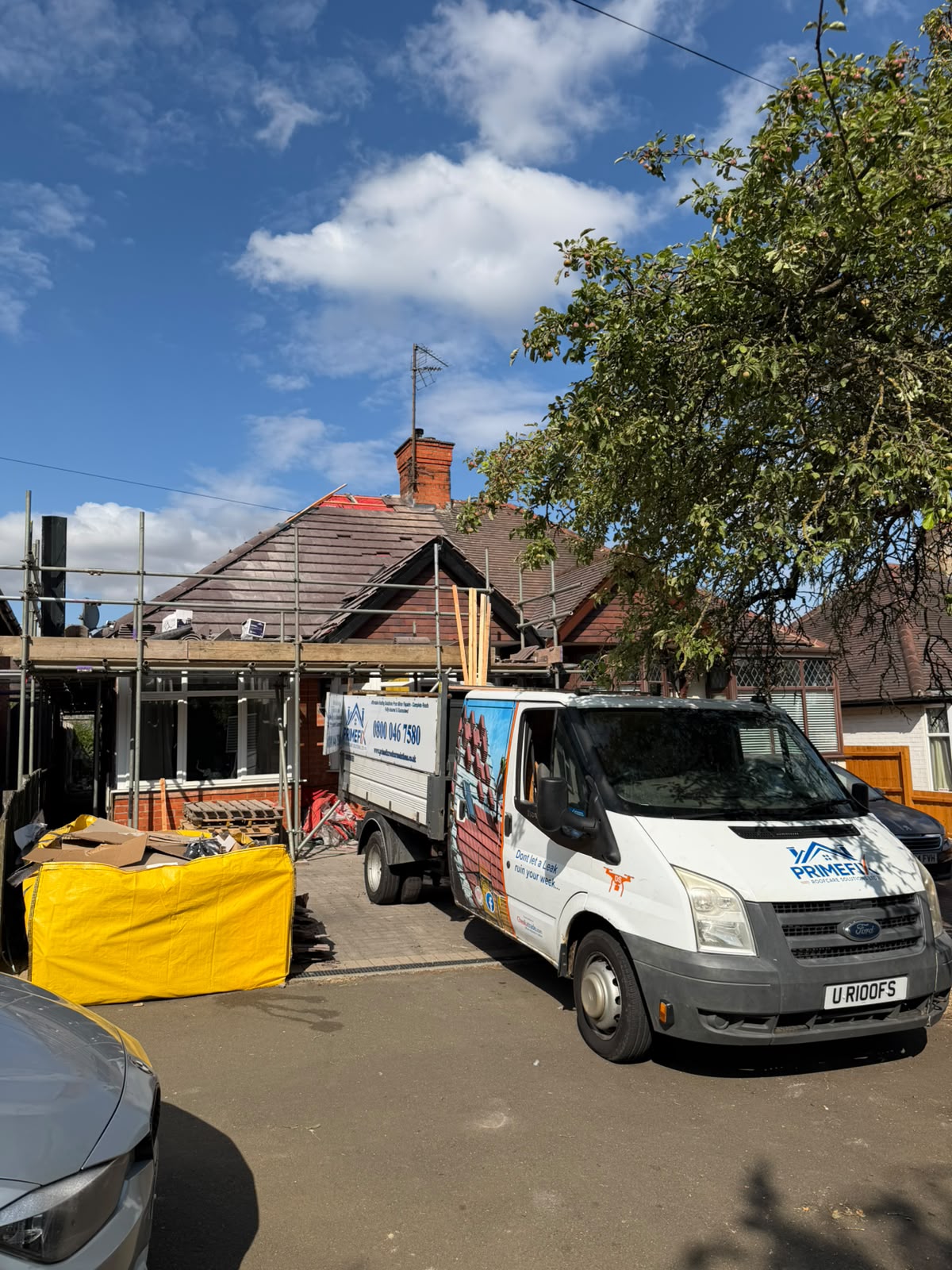 Primefix Roofcare van on driveway during residential re-roofing project with scaffolding