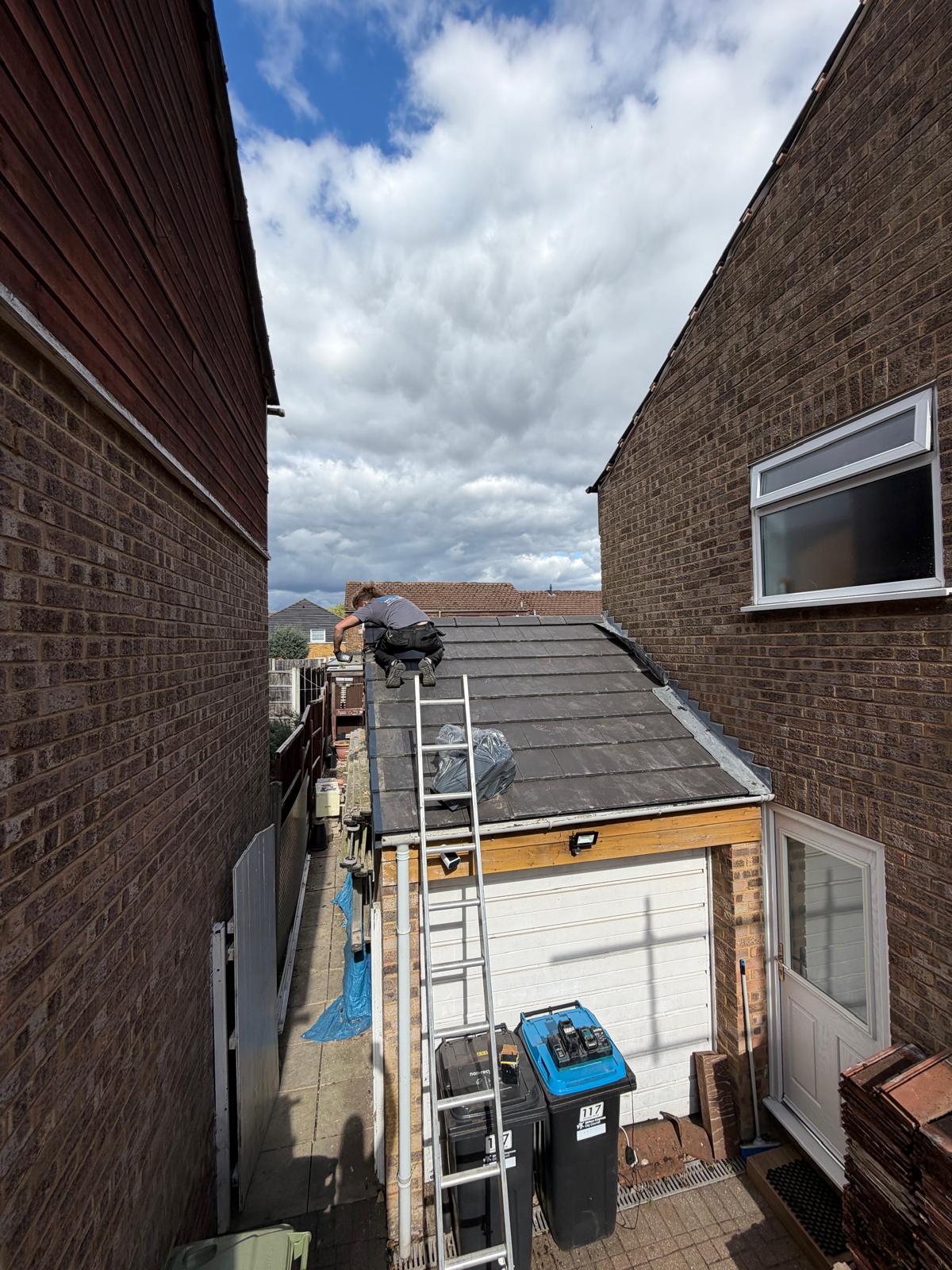Primefix roofer securing roof tiles and verge on residential garage roof repair