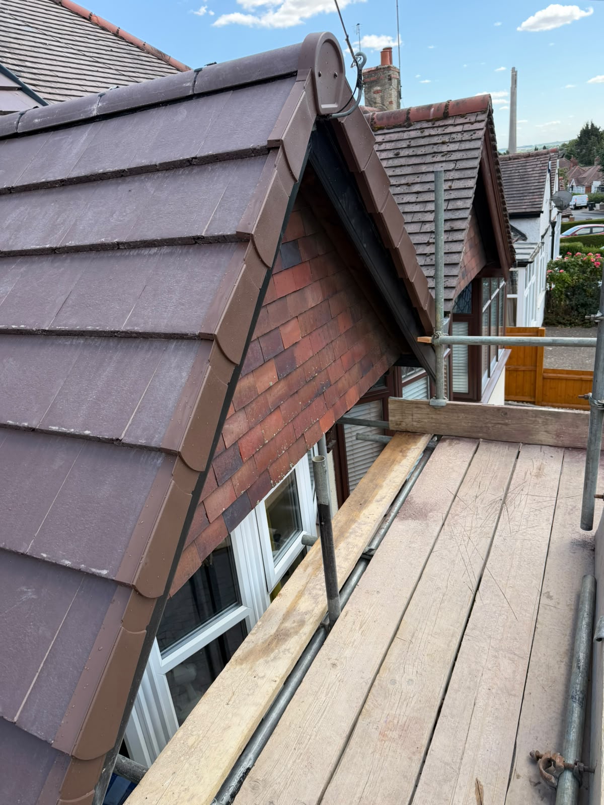 Precision dry verge system and ridge tile detailing on residential gable roof