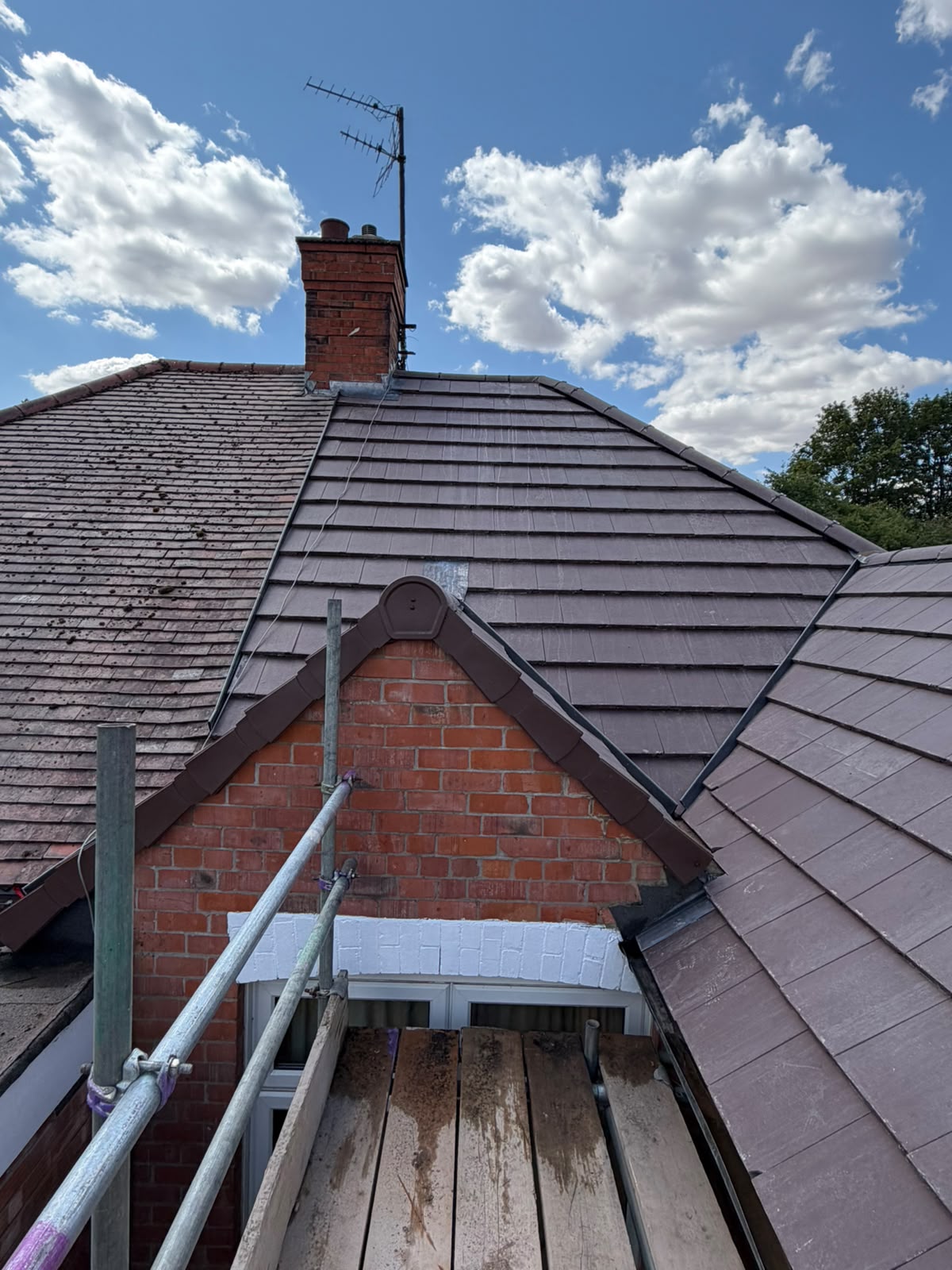 Extension re-roof with lead flashing detail and brown interlocking tiles
