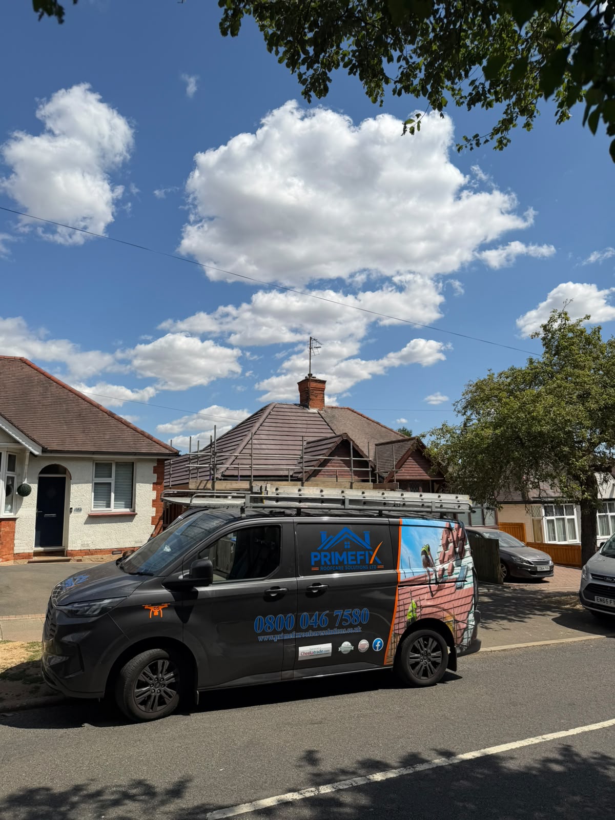 Primefix Roofcare van parked outside residential property with scaffolding erected for roof replacement