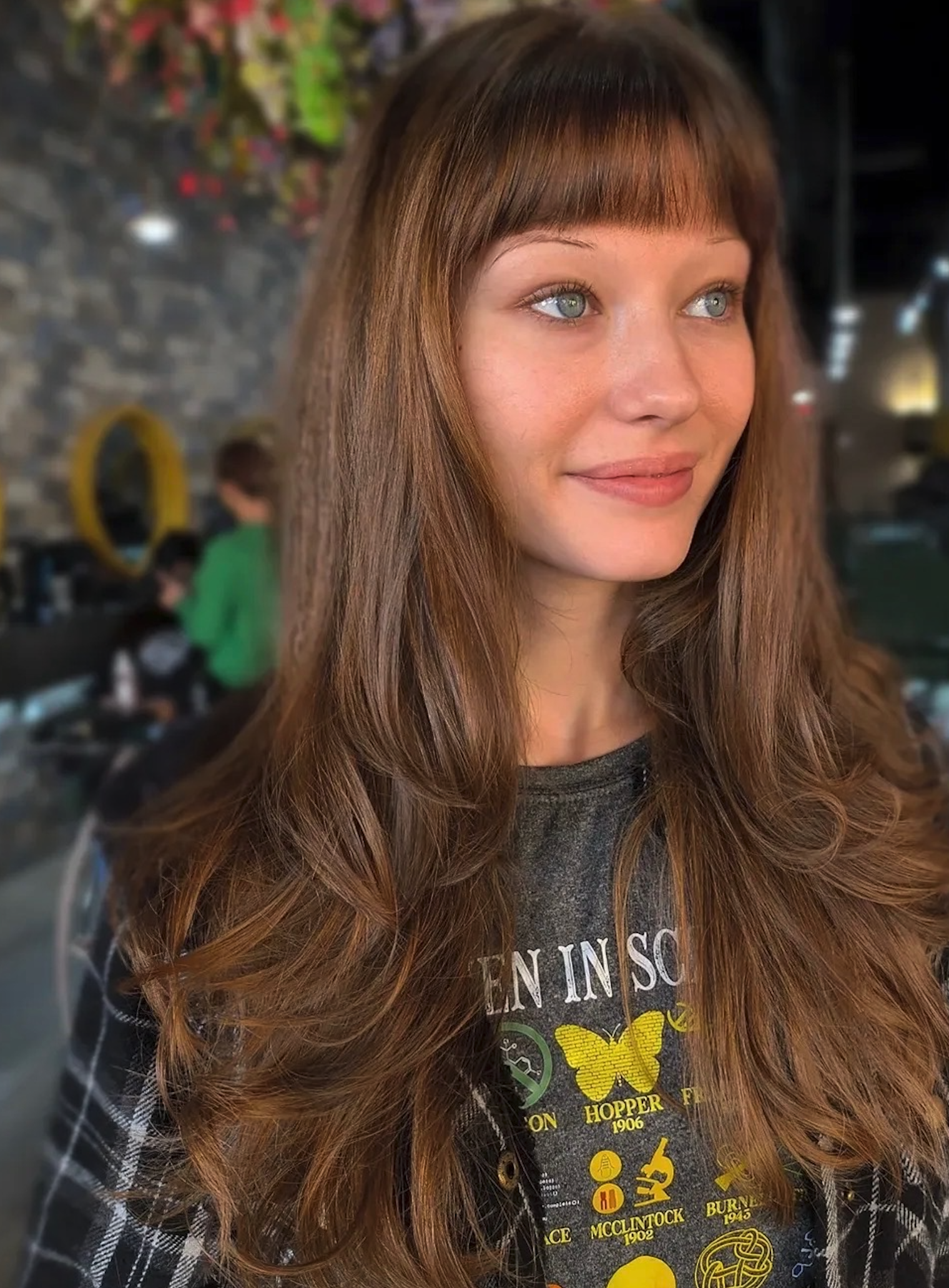 Dimensional brunette with soft waves and face-framing layers