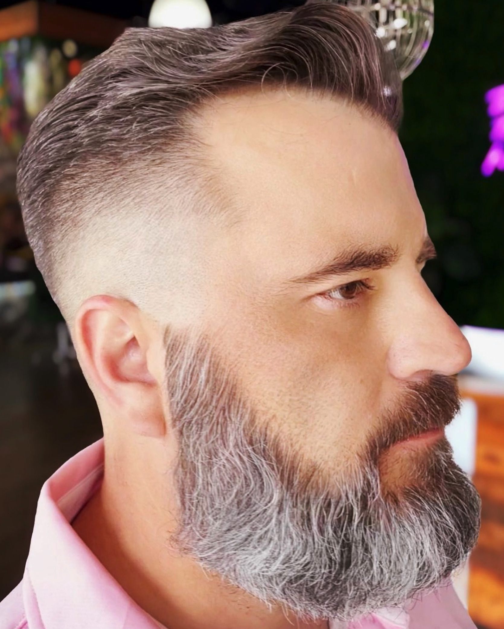 Men's gray blending with a natural fade and textured beard