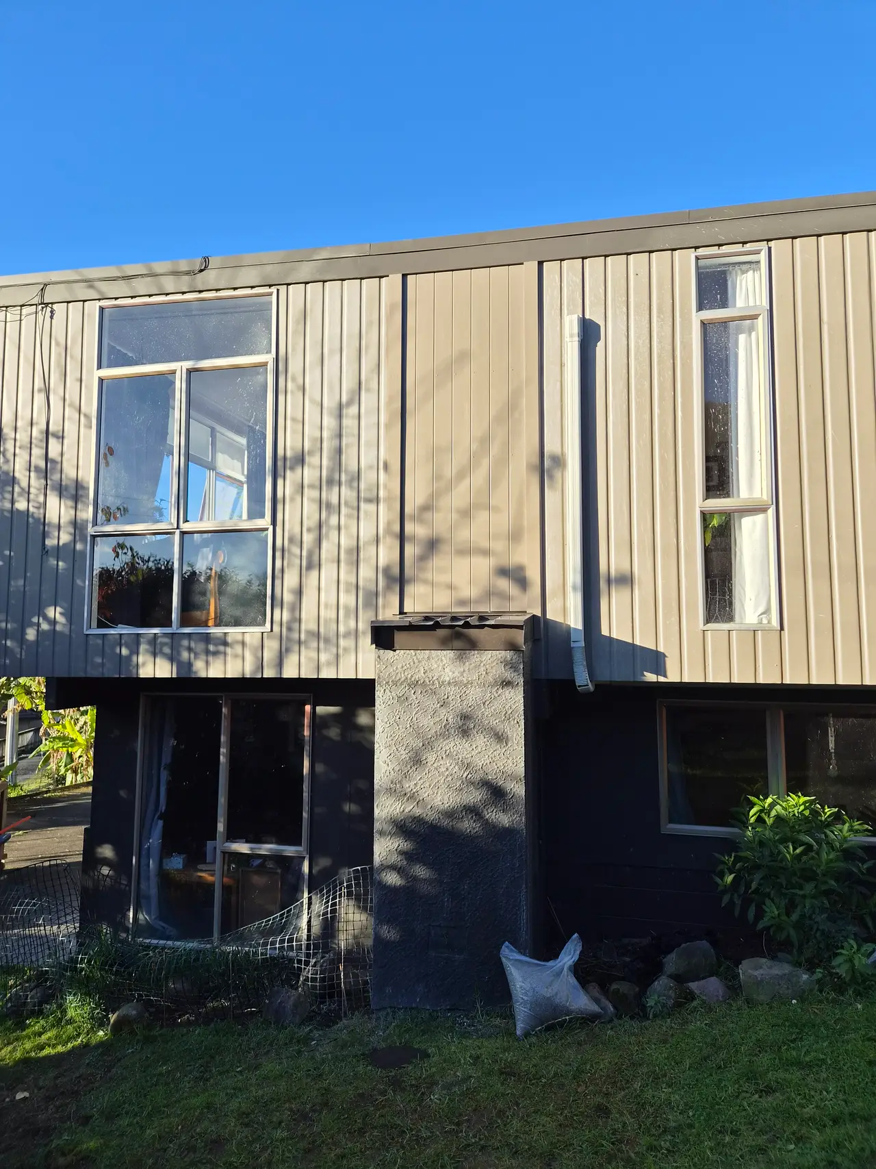 General Maintenance - Leaking chimney removed to sub-floor support. The finished exterior, re-clad with a fresh, durable finish and clean black base detail at handover.
