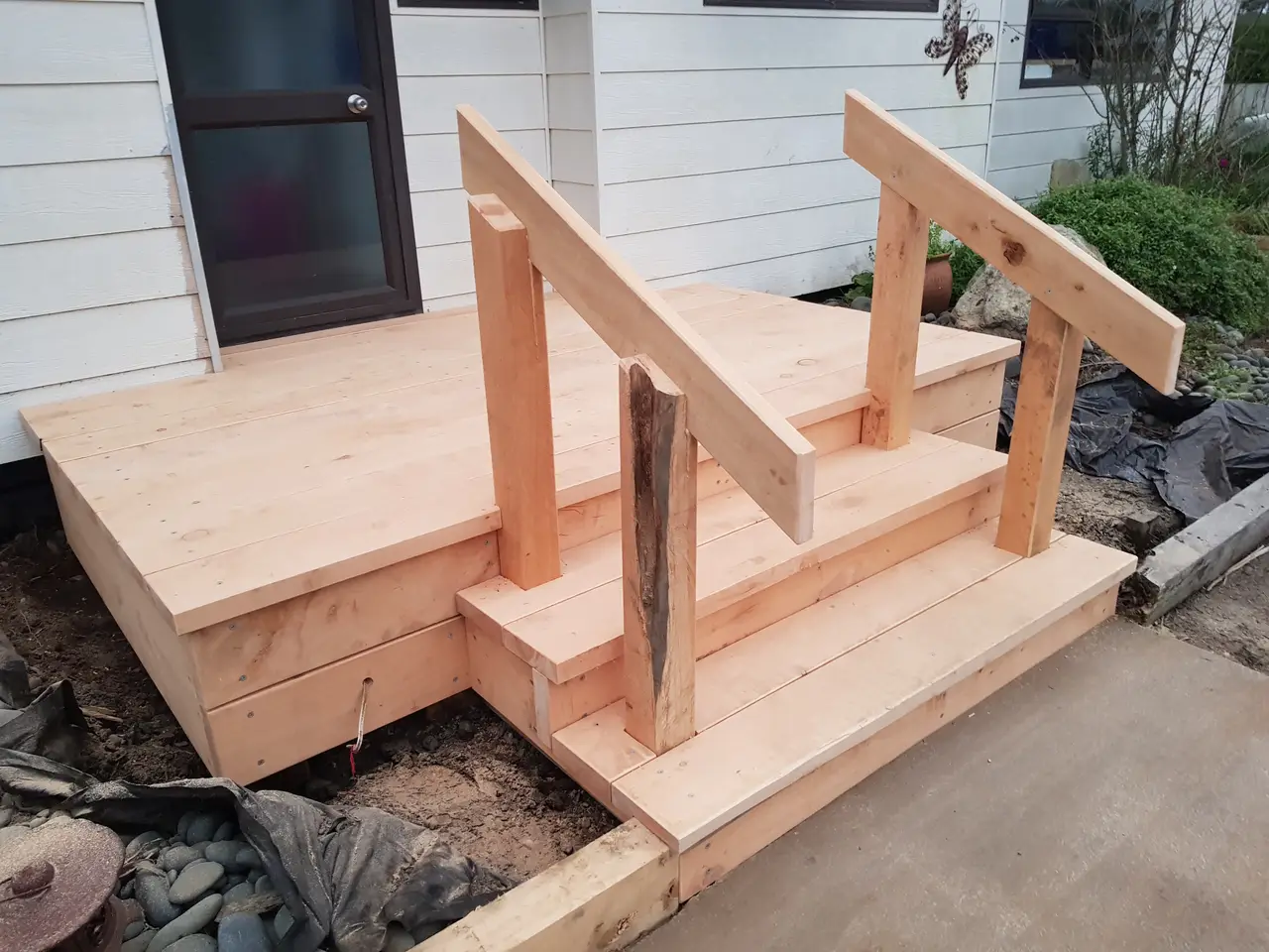 Small Timber Entry Deck with Steps - Side view showing the handrails, step framing and timber landing adjoining the home.