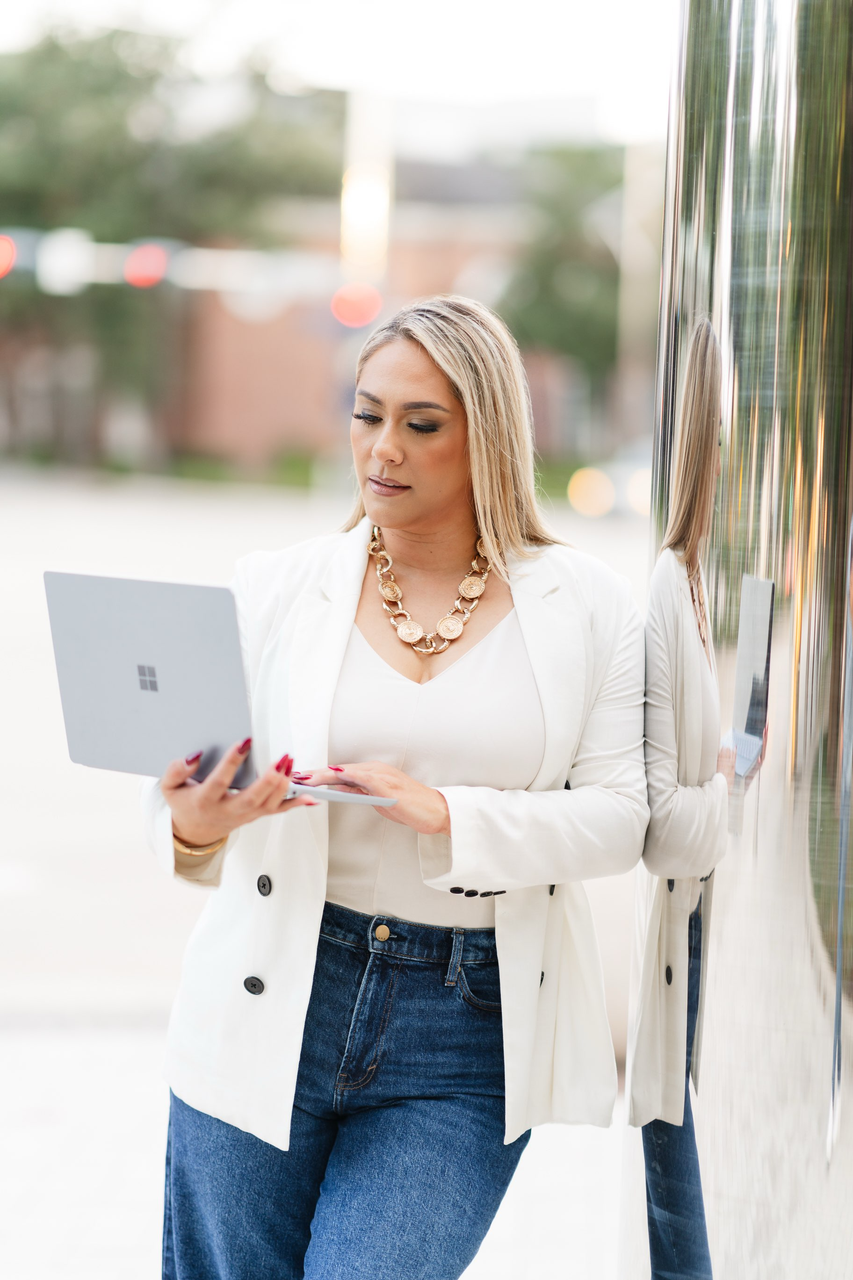 Elvira Trevino — Cactus Marketing founder working on laptop in Houston