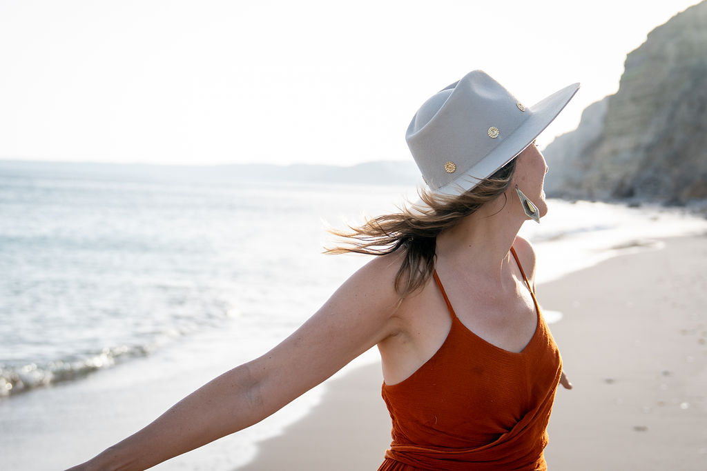 Maryke embodying feminine power on the beach