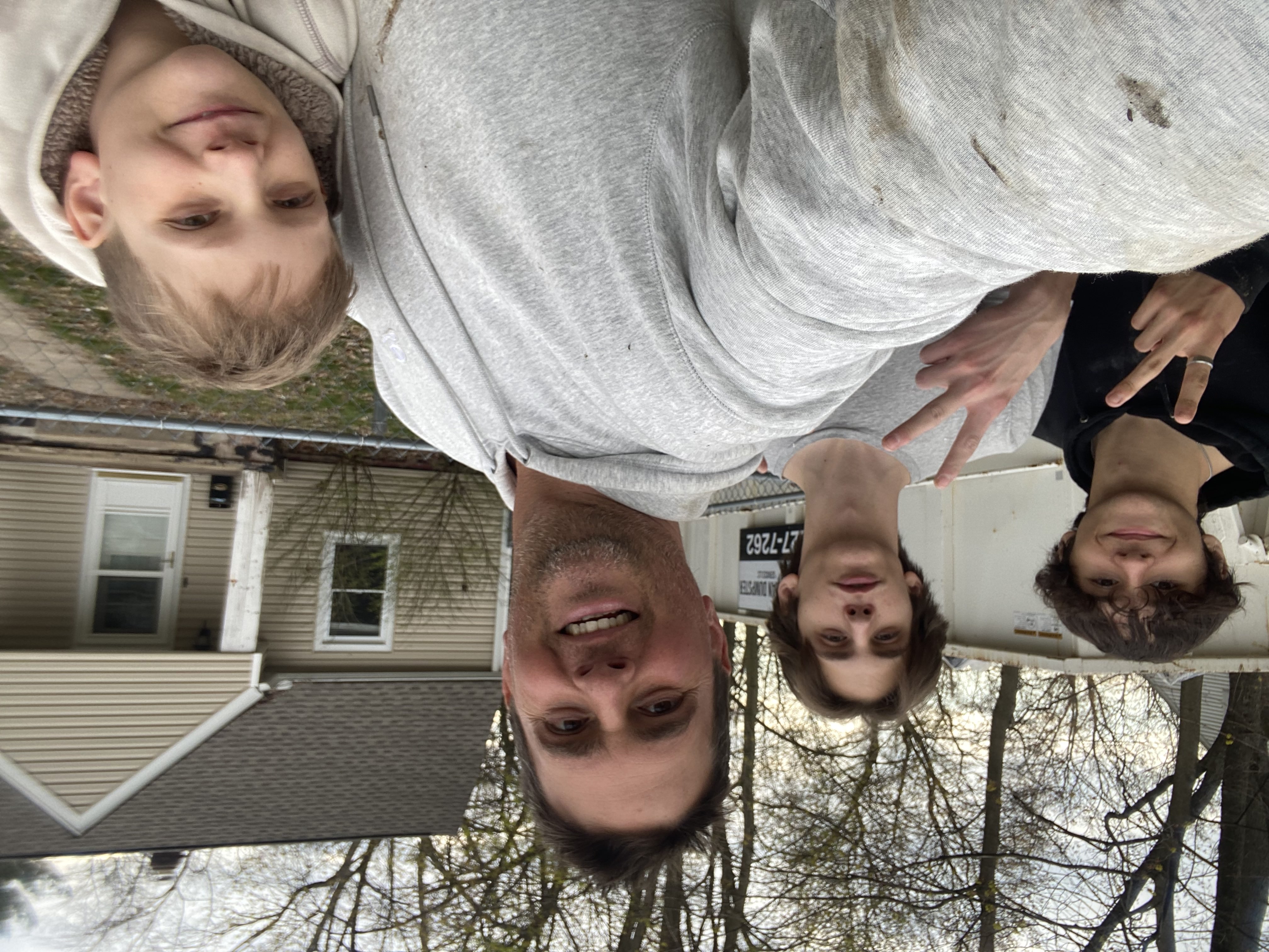 Justin Herrema with his four boys and three girls outside a property renovation