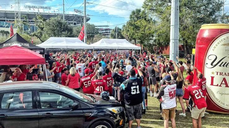 Huge tailgate crowd cheering outside the stadium