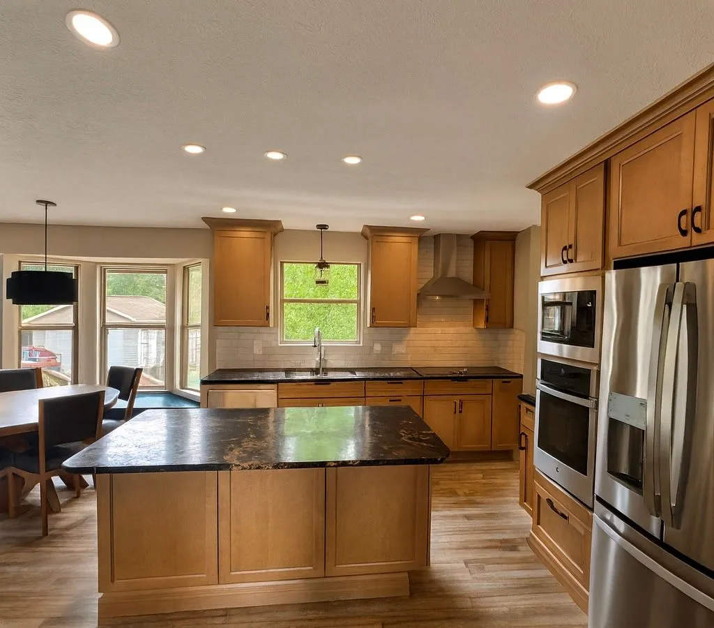 Warm Oak Kitchen with Granite Island & Bay Window Dining