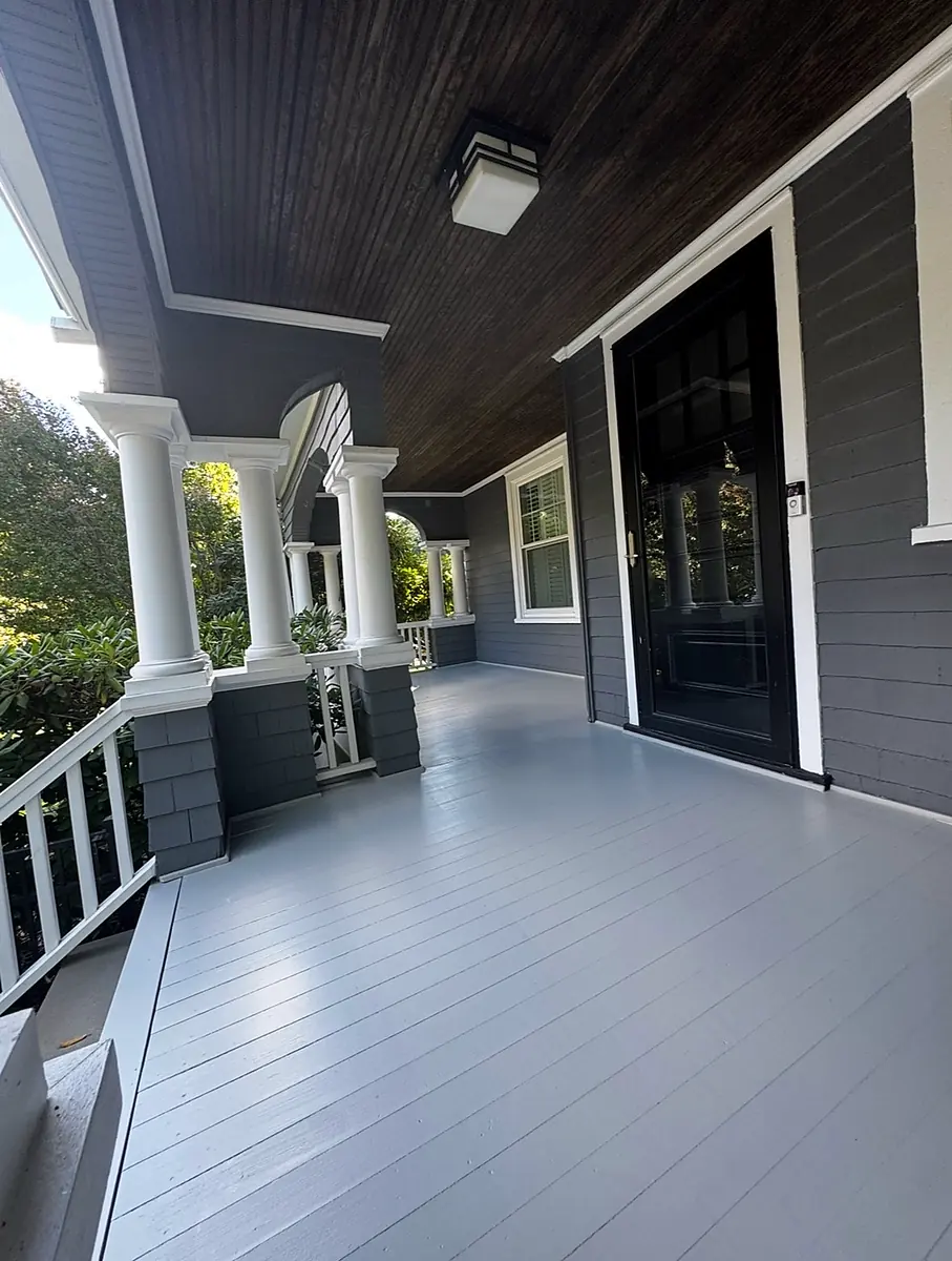 Restored front porch with painted deck and columns in New Jersey