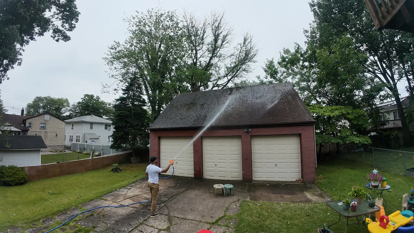Pressure washing and soft washing garage roof in New Jersey