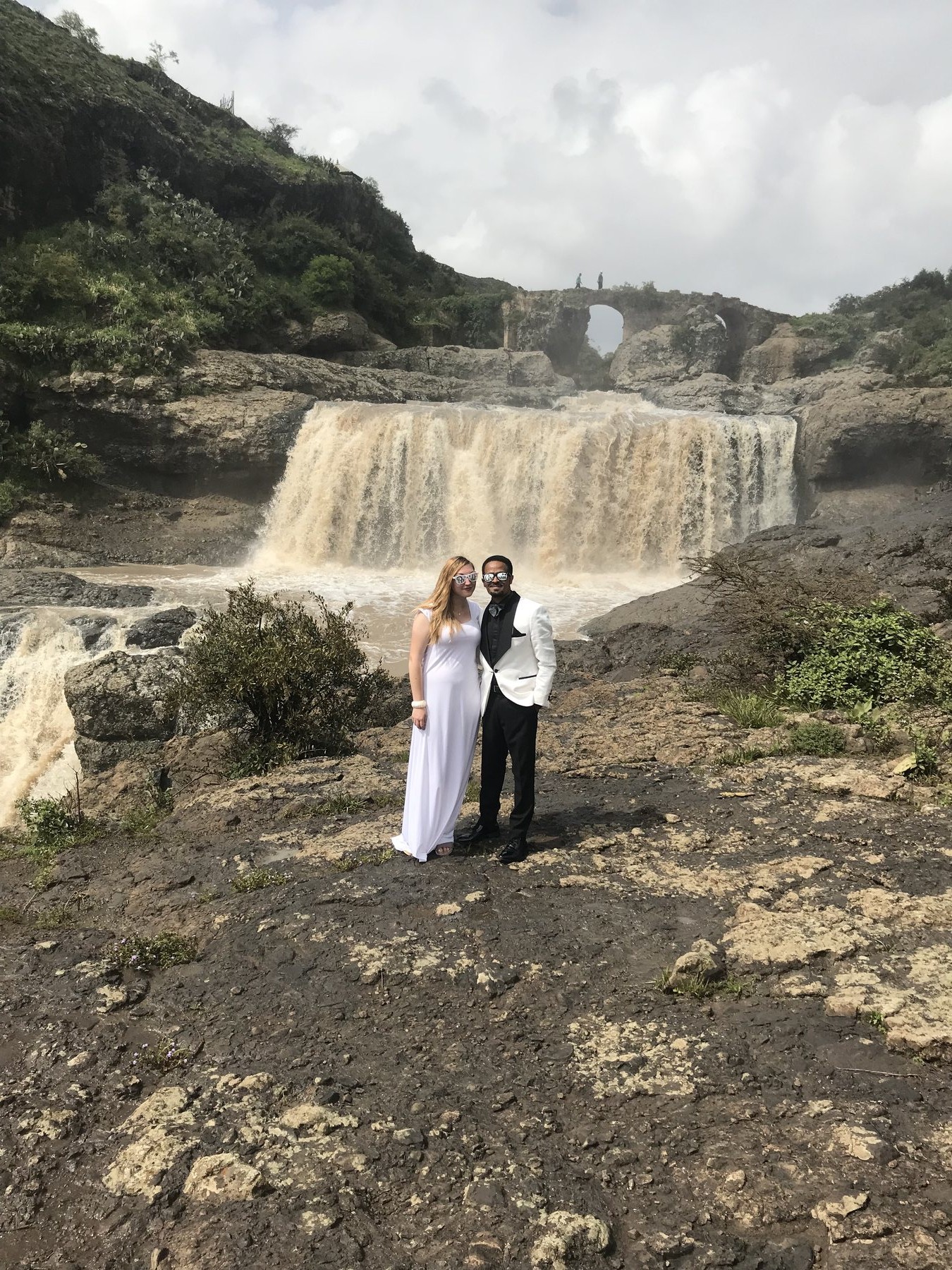 Wedding photo of Abraham and Hannah in Ethiopia, in front of a waterfall