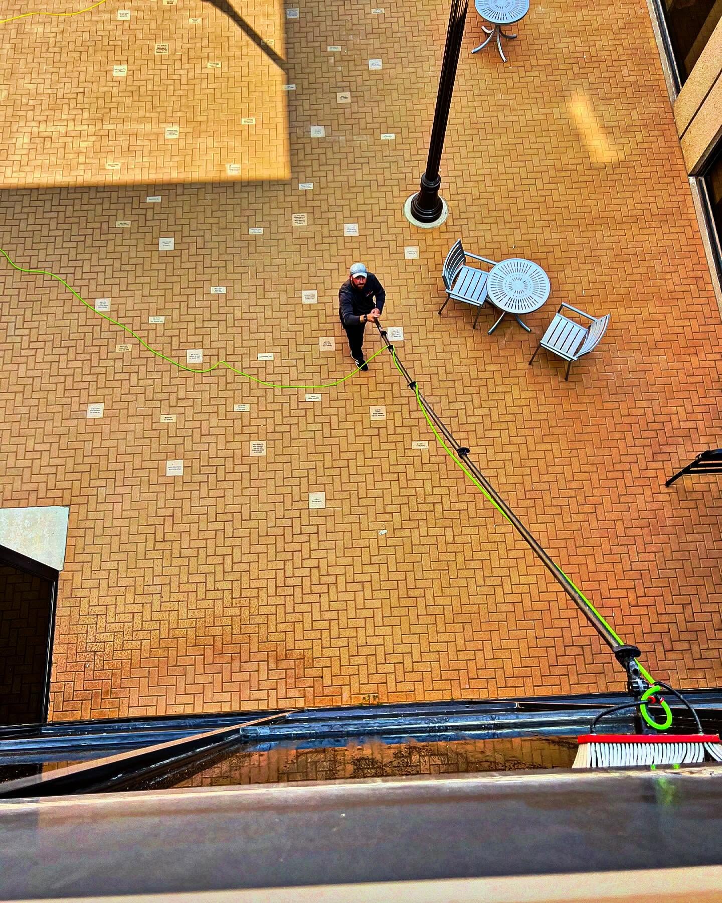 Two Luminous team members with poles in modern office lobby