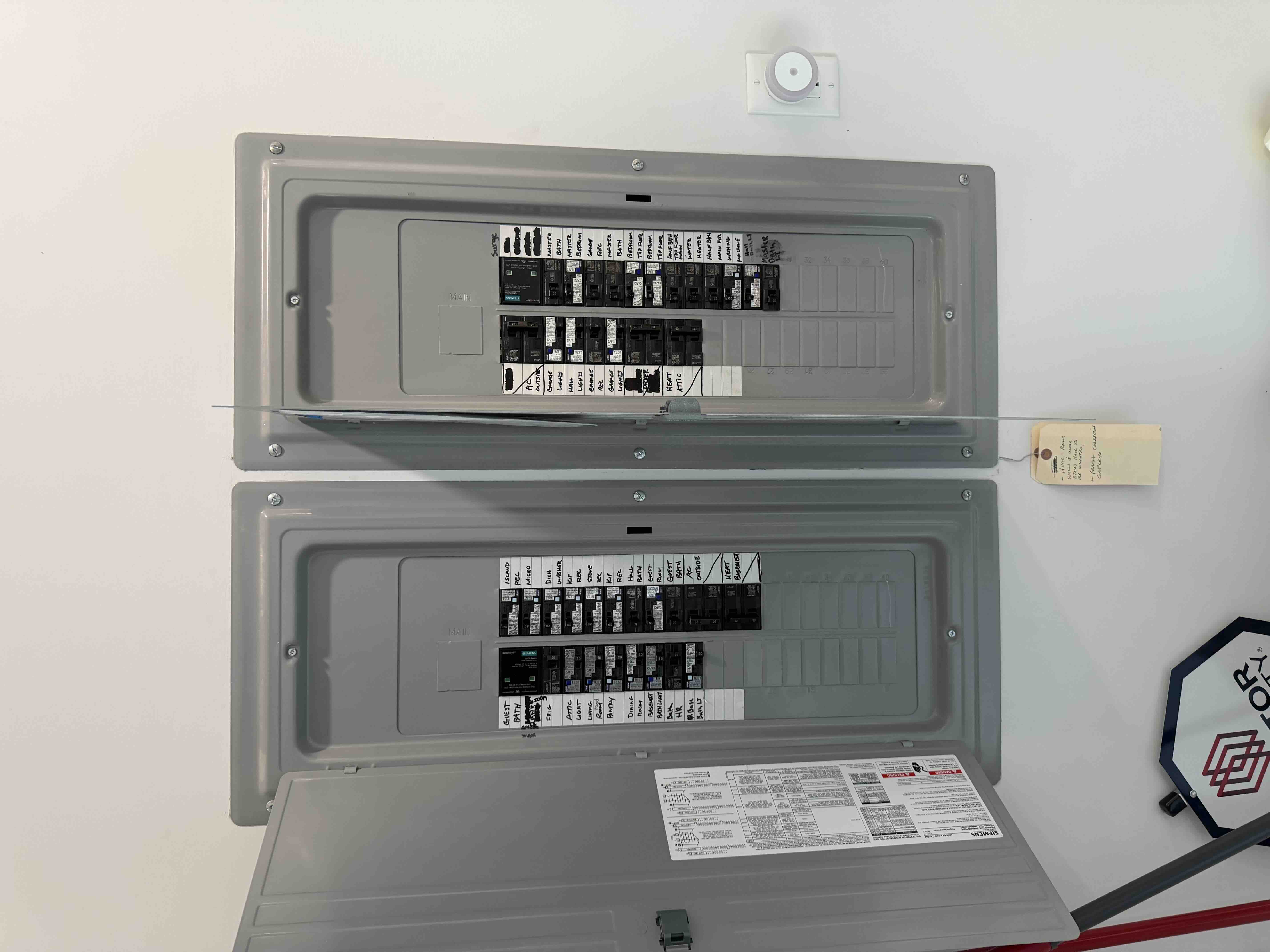 Completed dual breaker panel directory with each circuit clearly labeled by room for easy homeowner reference