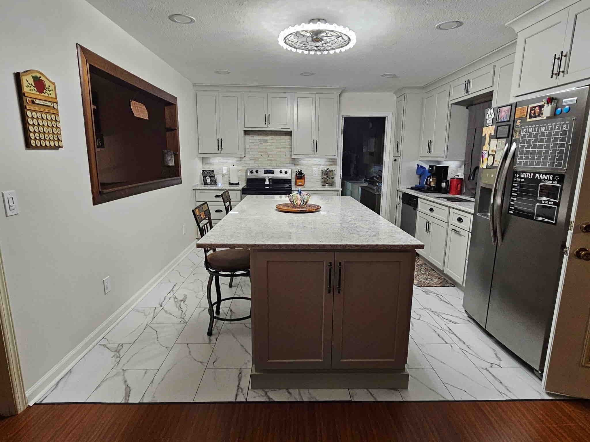 Decorative light fixture installed over a kitchen island
