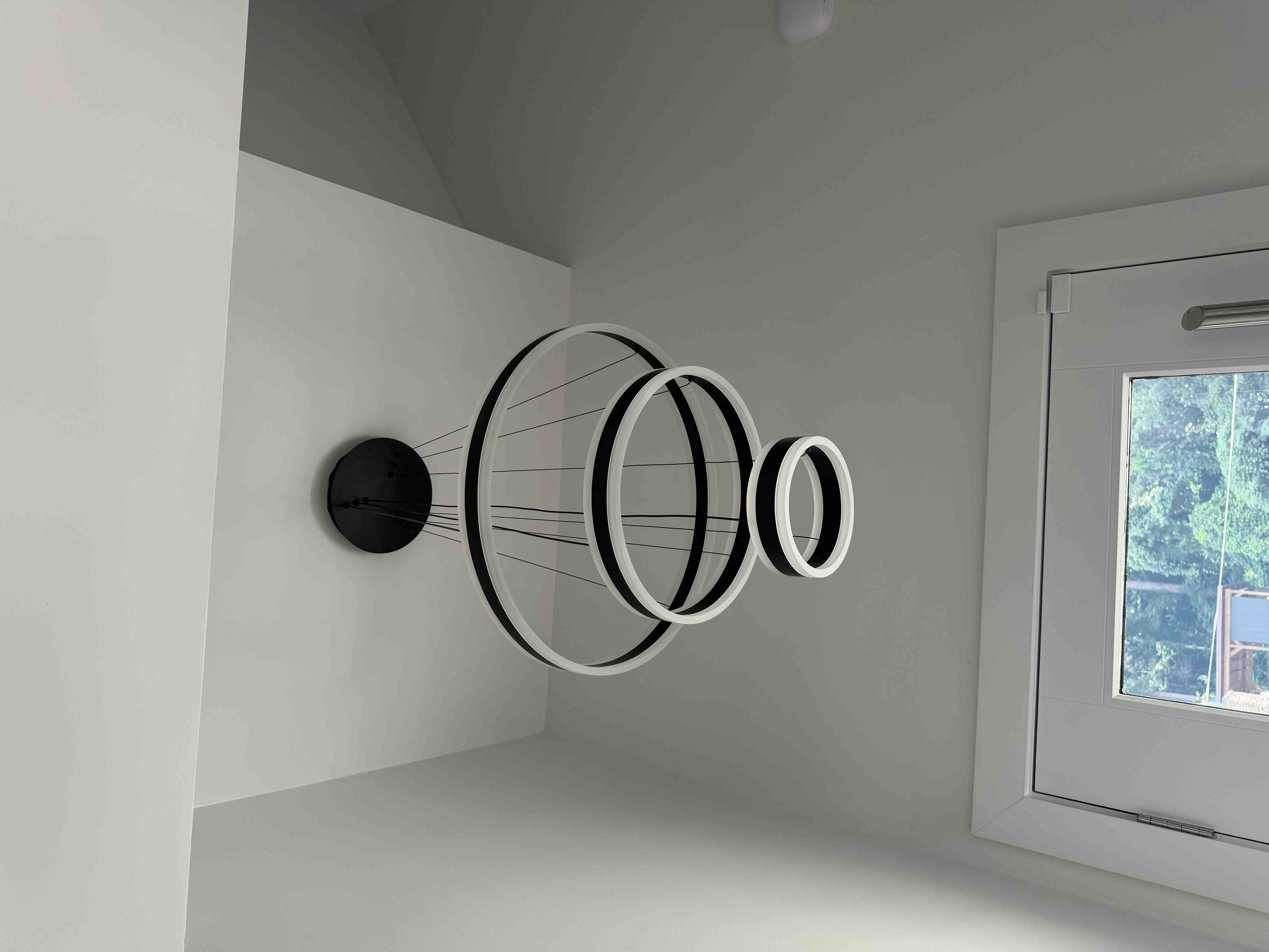 Modern multi-tier concentric circular ring LED pendant chandelier in black and white