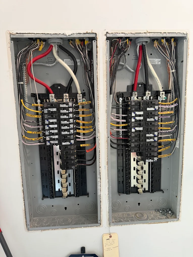 Neatly wired dual electrical breaker panels installed by On Point Electric, showing careful workmanship