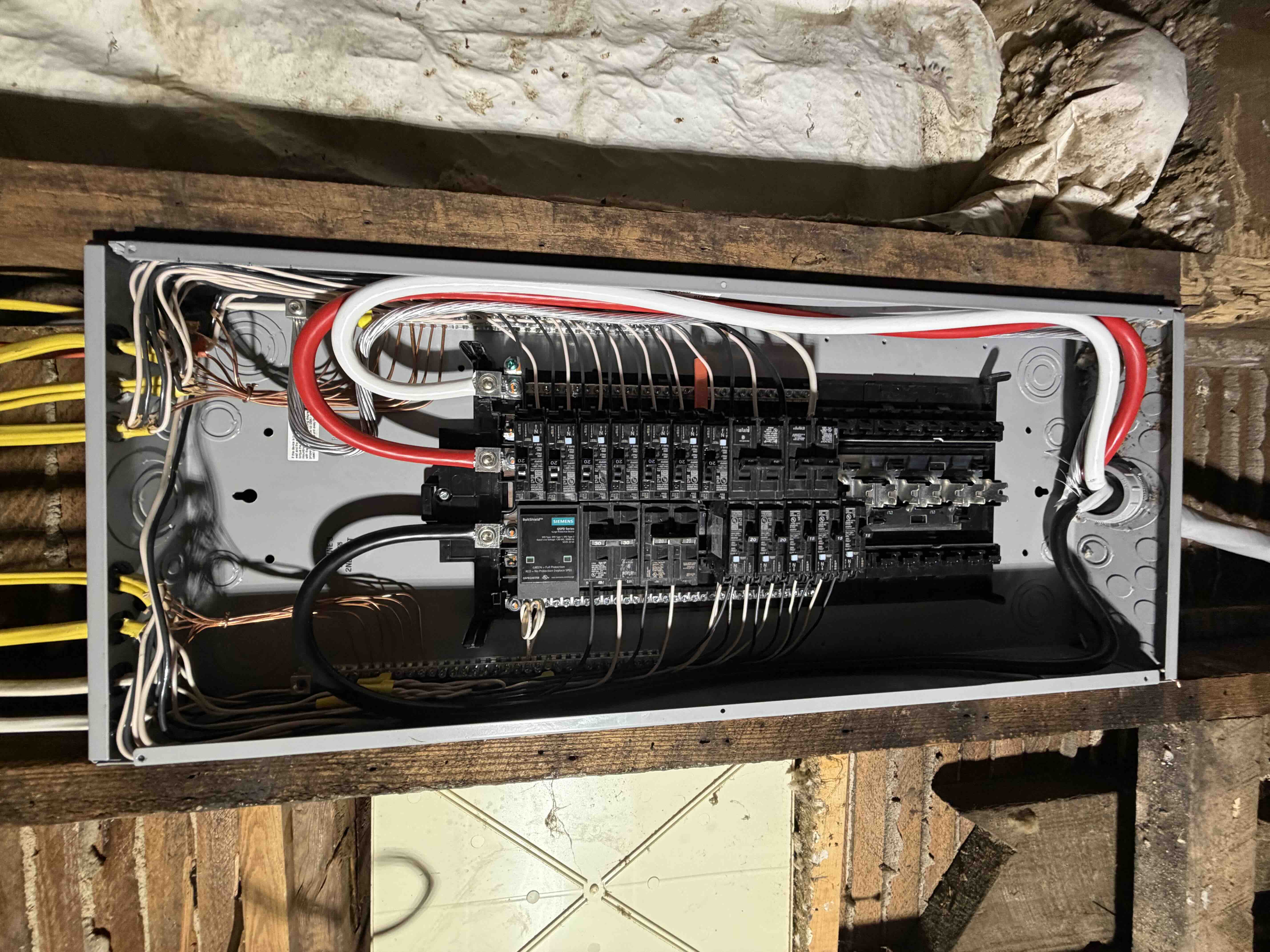 Detailed view of main service entry feeder wires connected to Siemens 200A main lugs with surge protection device