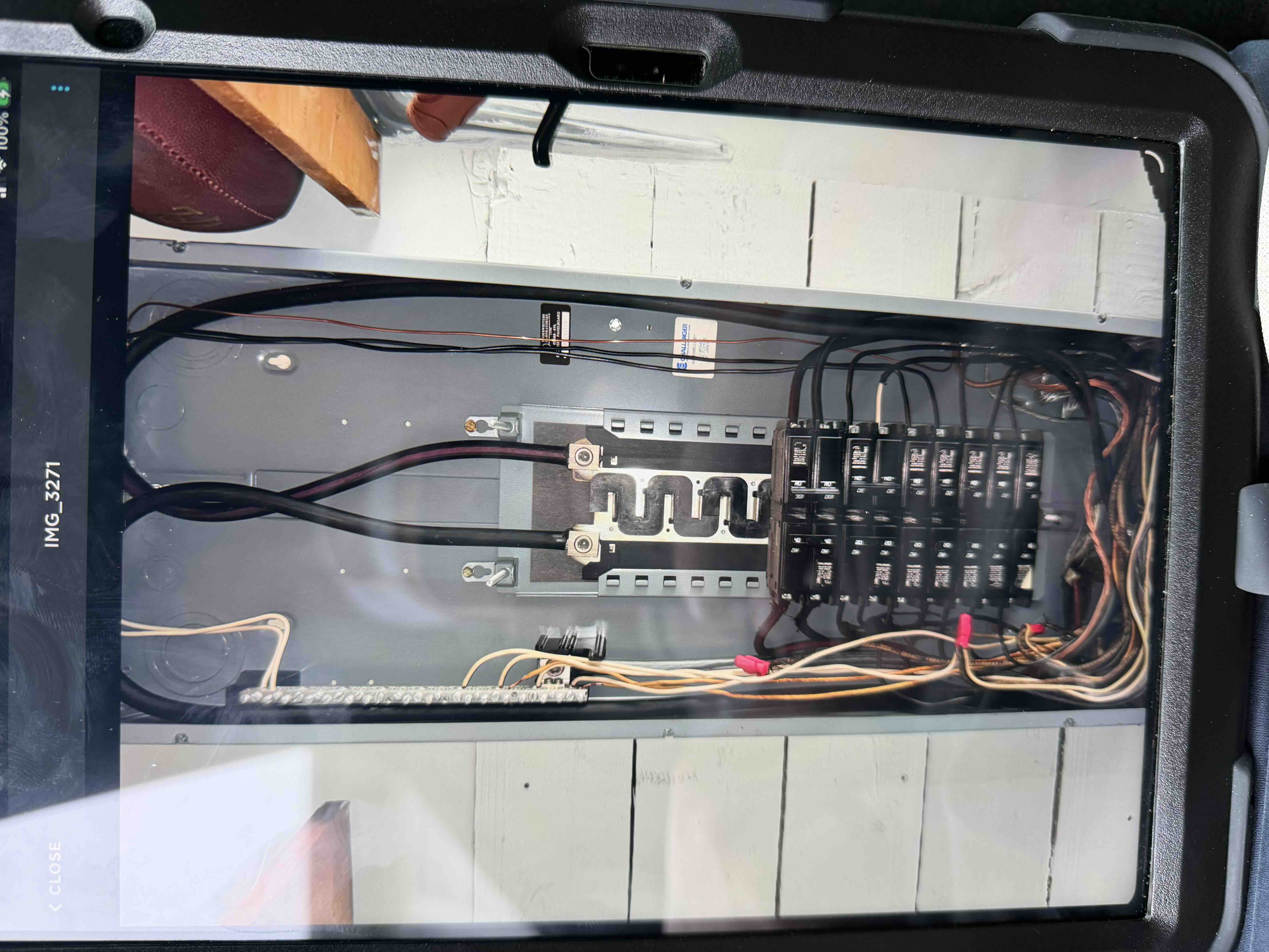 Organized circuit wiring inside an open breaker panel during an inspection