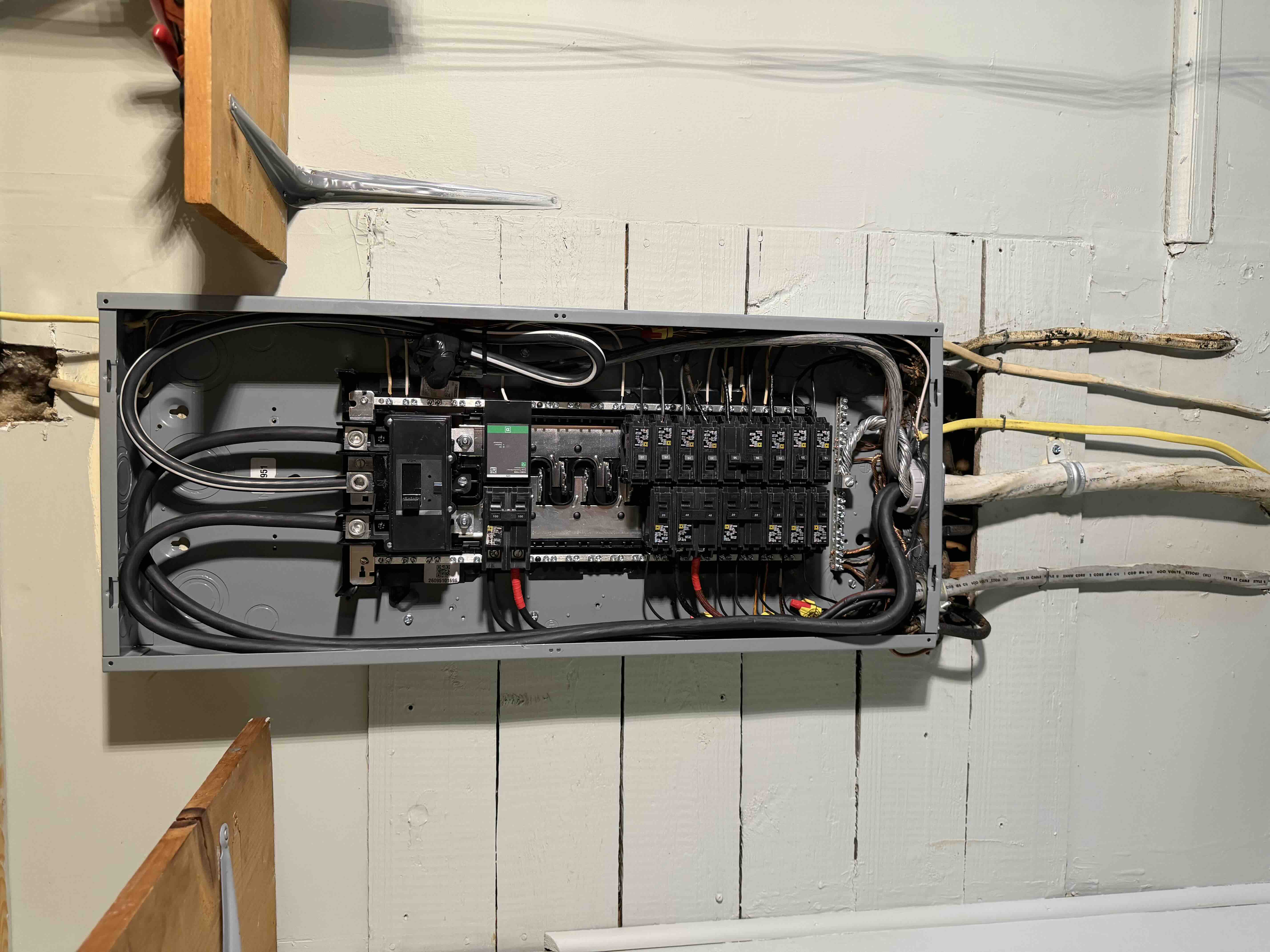 Open interior of a newly wired Square D breaker panel showing organized neutral and hot conductors