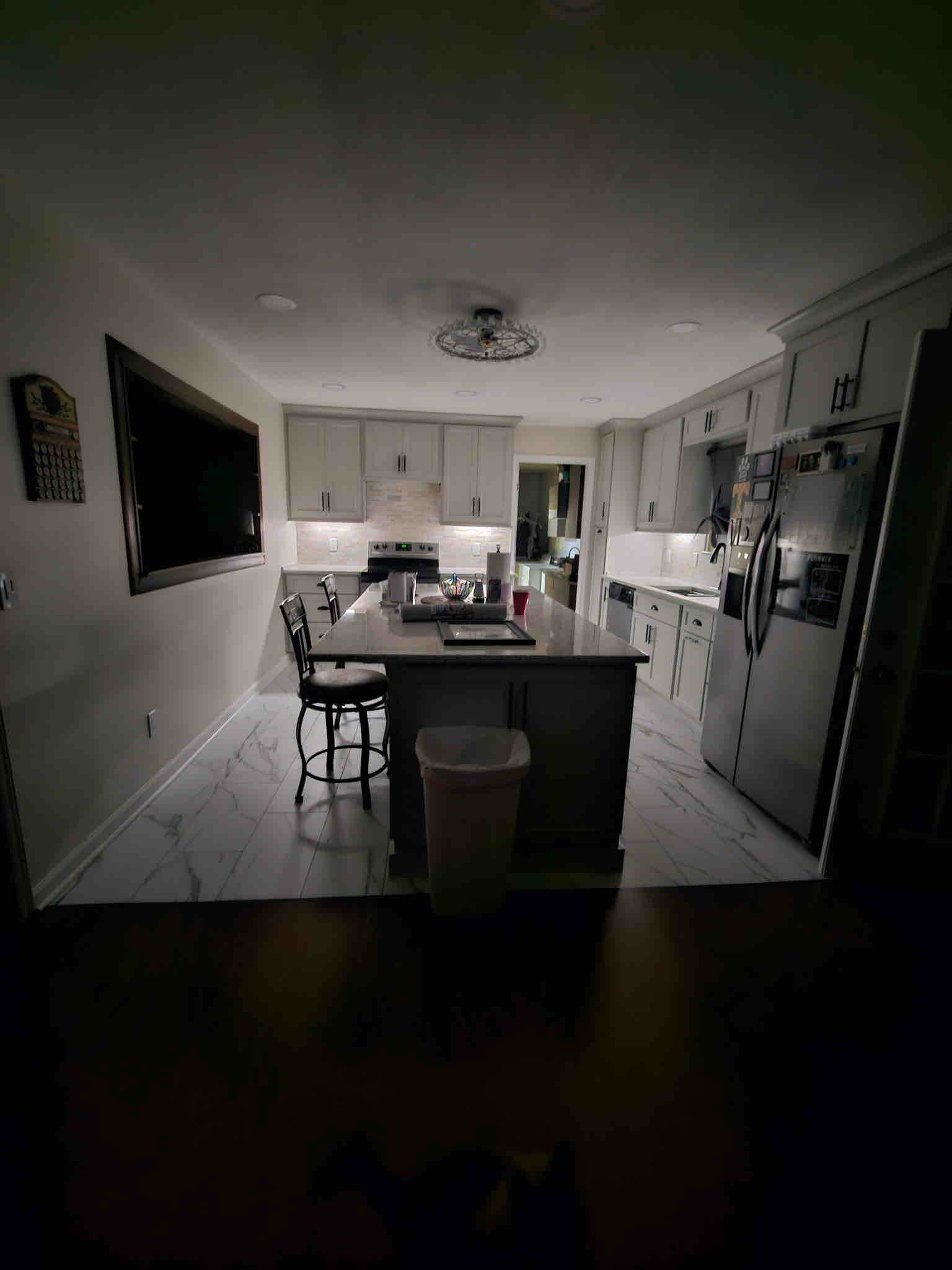 Full kitchen view showing recessed and decorative lighting layout after electrical renovation work