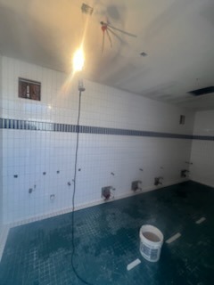 White grid tile shower with teal mosaic accent border and matching floor by Level 4 Tile and Stone San Diego