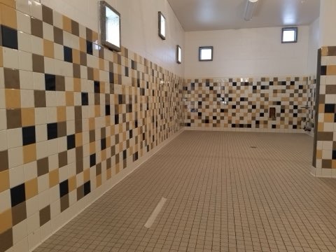 Multi-color mosaic tile shower room installation with matching floor by Level 4 Tile and Stone San Diego