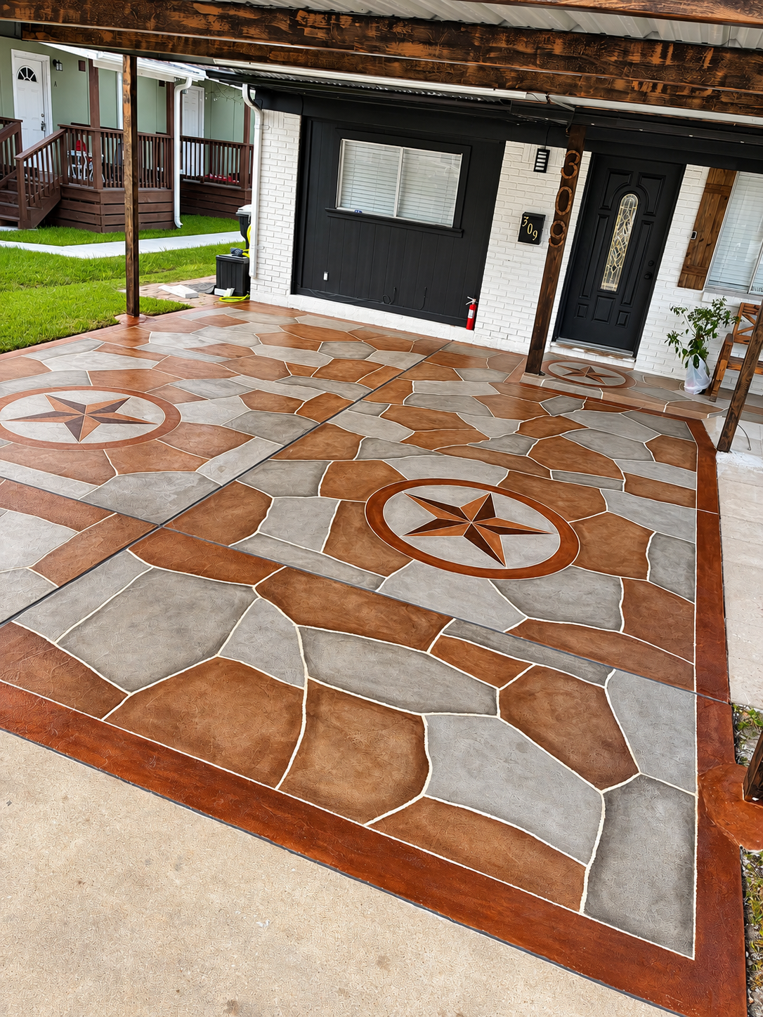 Custom decorative carport and walkway surface with Texas star medallions and flagstone design