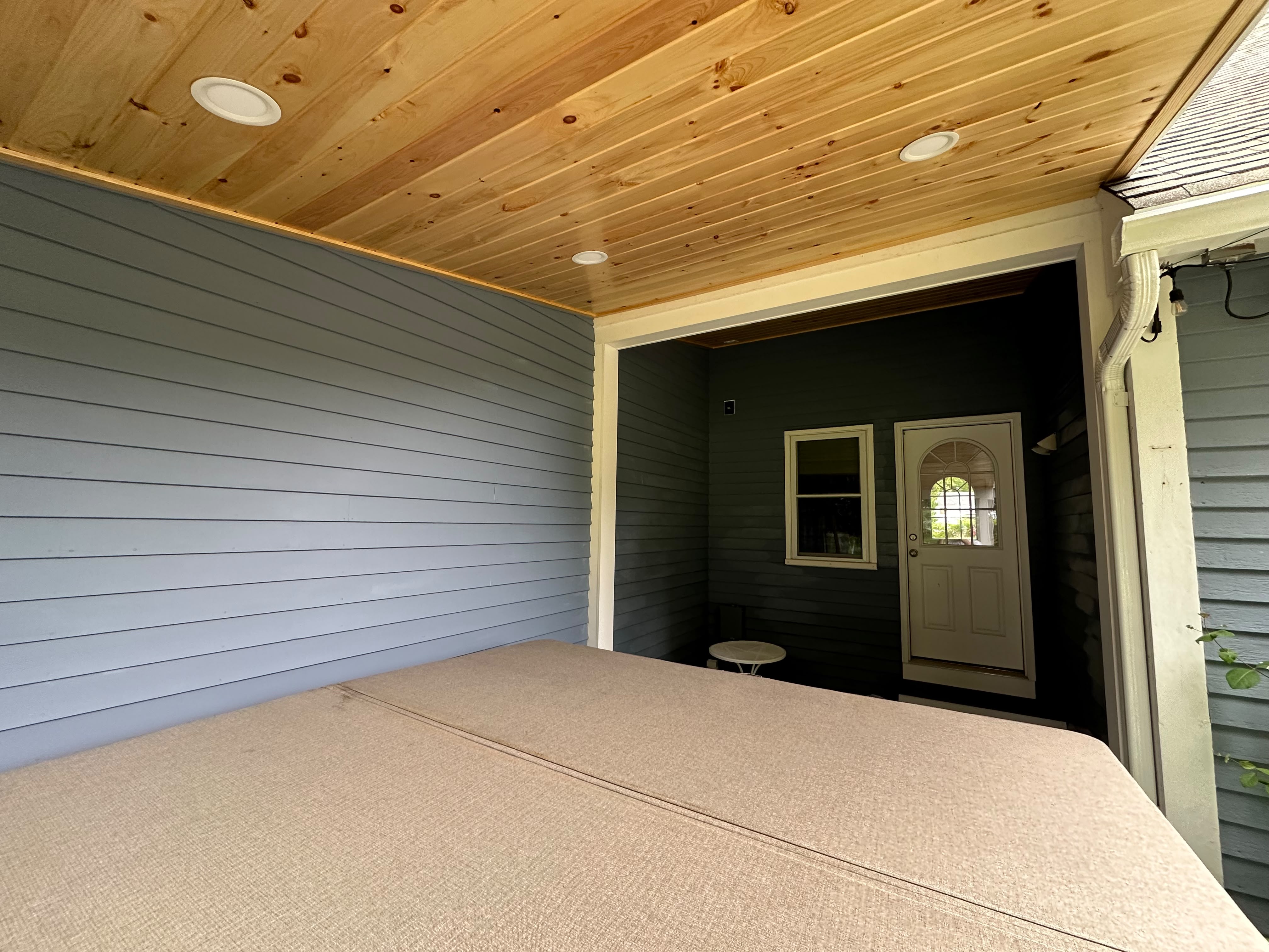 Exterior painting — freshly painted covered porch and siding on a Central MA home