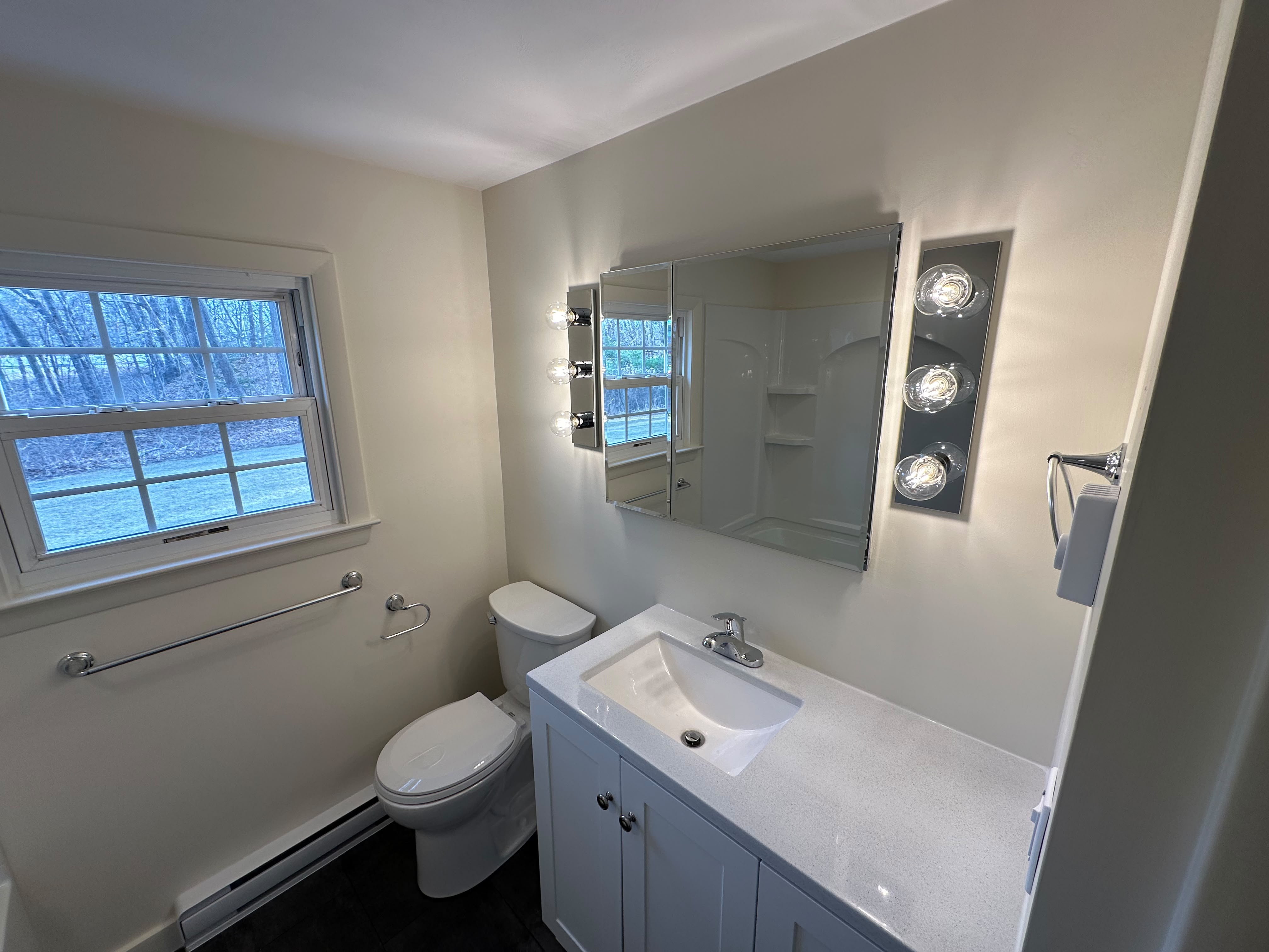 Freshly painted bathroom with neutral walls and trim in a Central MA home
