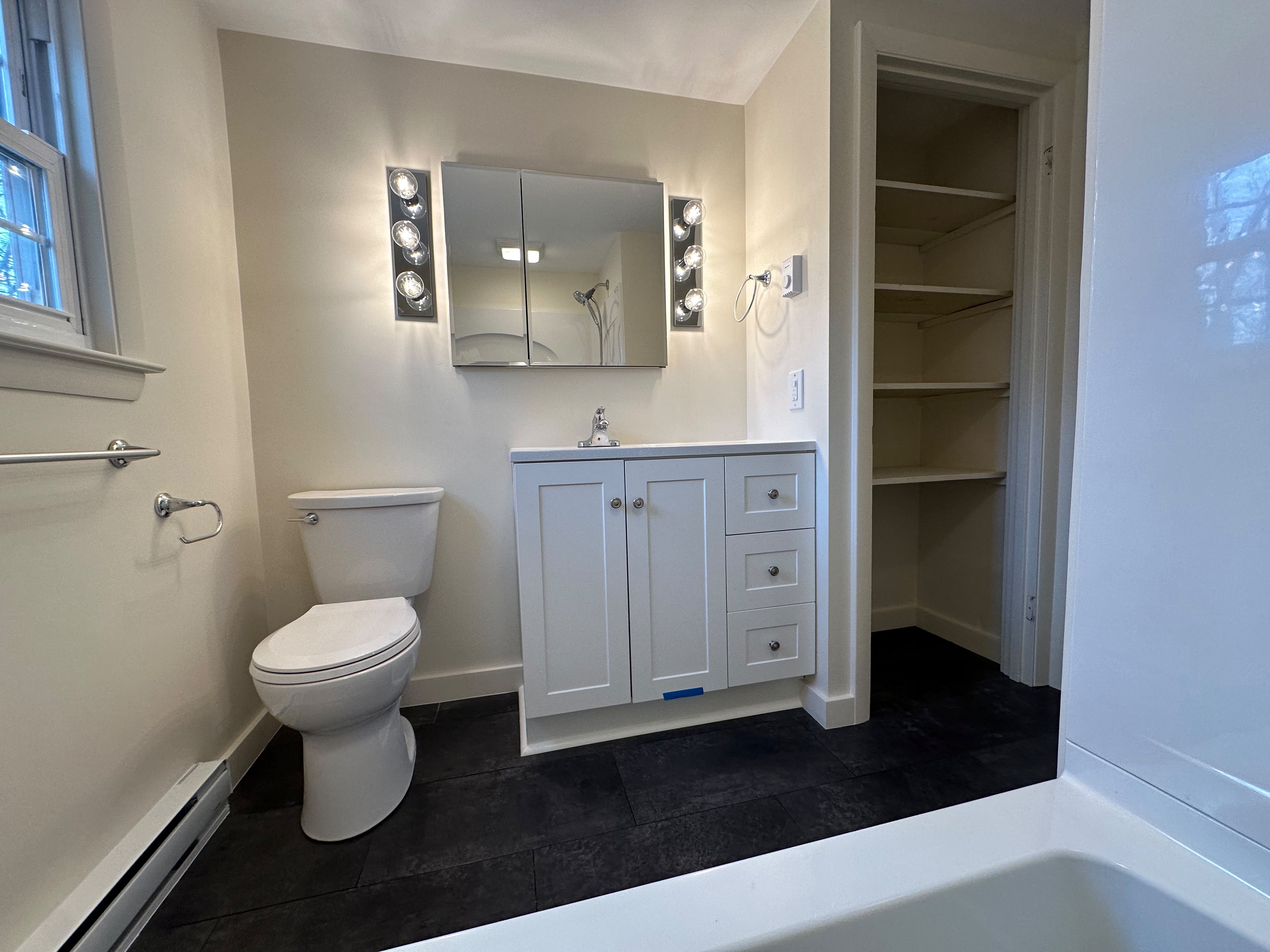 Freshly painted bathroom with white vanity and trim in a Sterling MA home