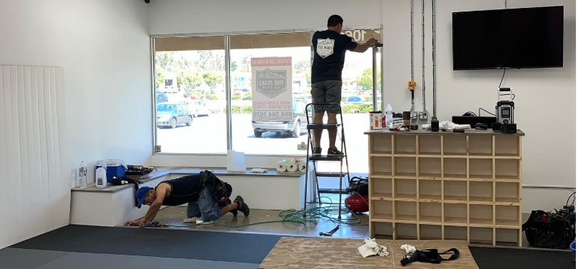 Coaches working on the initial buildout of Five Peaks Jiu Jitsu academy in 2019