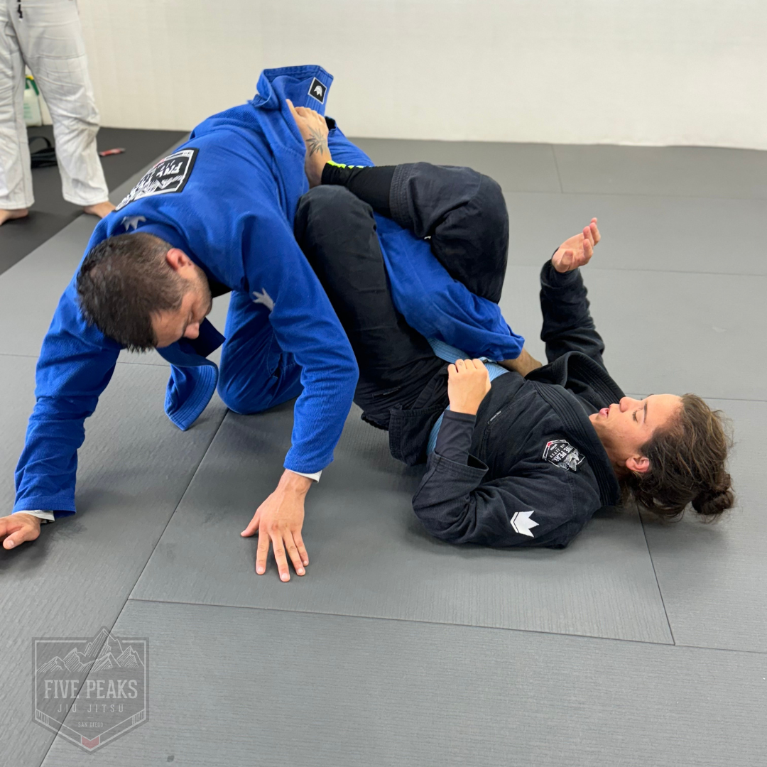 Adults grappling on the mat during no-gi jiu jitsu training at Five Peaks Jiu Jitsu