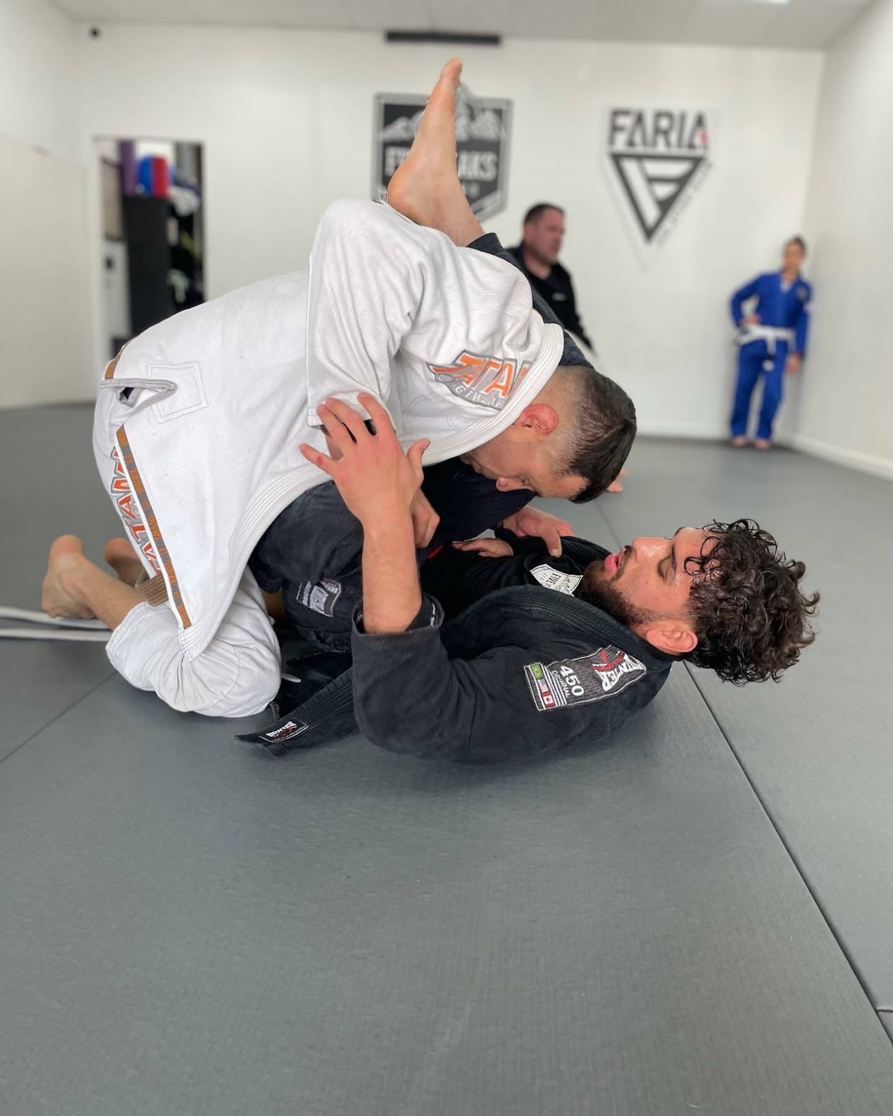 Adult student passing guard during jiu jitsu training at Five Peaks Jiu Jitsu