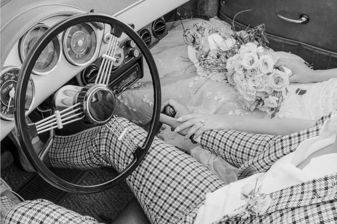 Black and white editorial luxury wedding photography of bride and groom in vintage Porsche car holding floral bouquet by Relative Vision Studio in Claremont & Los Angeles