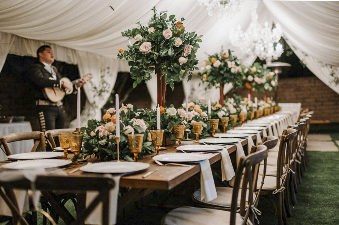 Commercial event photography of luxury tented banquet tables, amber glassware, floral centerpieces, and mariachi performance in Pomona & Los Angeles by Relative Vision Studio