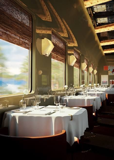 Orient Express dining carriage set with white linens and elegant table lamps