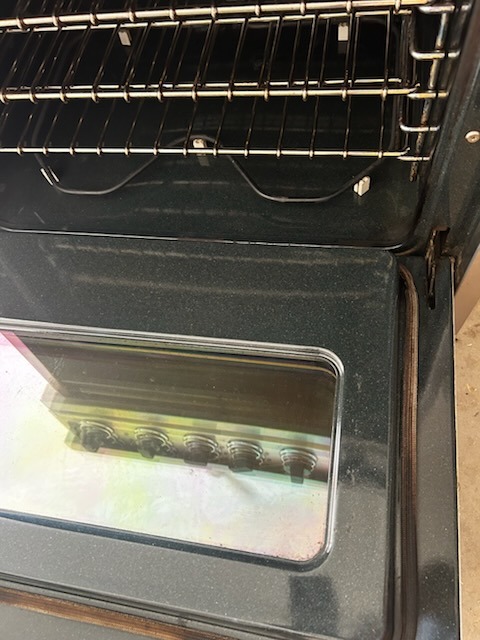 After cleaning: Crystal clear oven door glass and gleaming racks inside a spotless oven