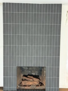 Floor-to-ceiling vertical stack tile fireplace surround and hearth