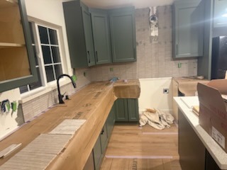 Artisan kitchen tile backsplash and dark custom cabinetry installation