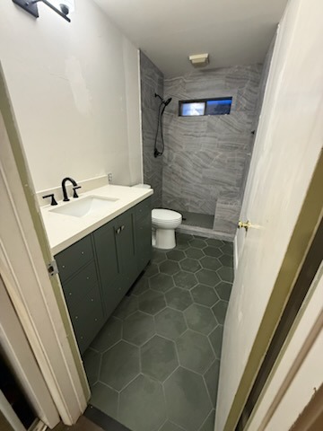Complete master bathroom renovation with custom vanity cabinet, quartz countertop, black fixtures, and hex tile