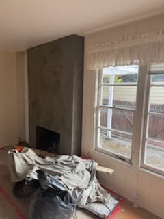 Custom smooth plaster fireplace build and hearth structure