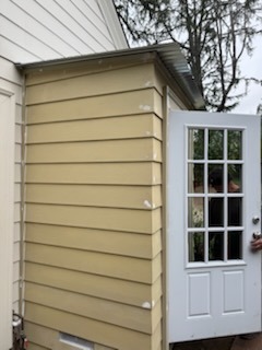 Custom exterior siding enclosure and French grid entry door installation