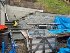 Natural flagstone retaining wall and stair construction on a sloped backyard