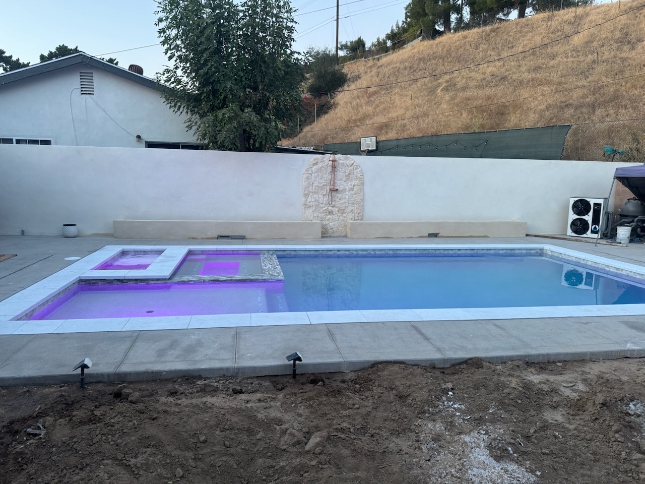 Finished Pool Deck & Stucco Retaining Wall